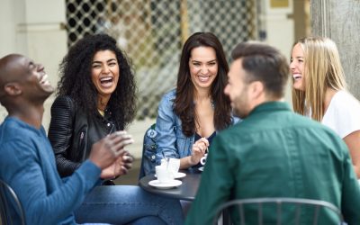 happy-friends-laughing-and-having-coffee-together